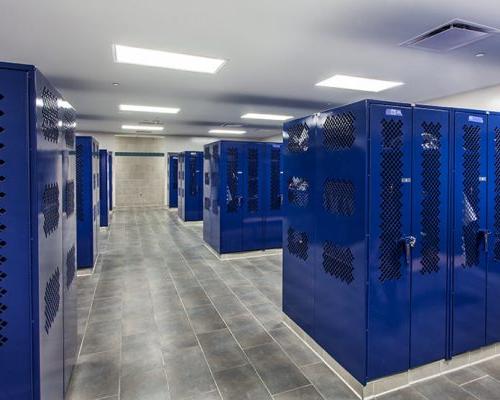Locker Room with bright blue lockers and grey tile surfaces