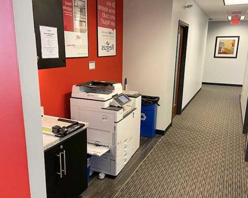 Hallway with printer station in the Fort Myers office