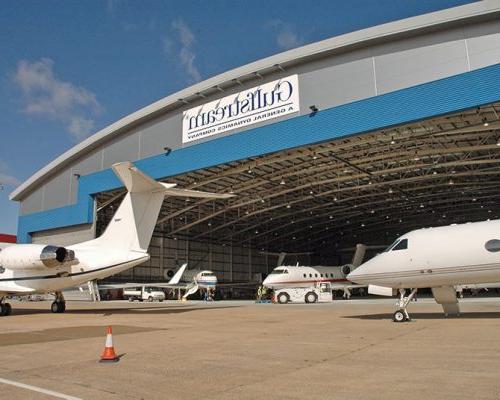 Exterior of 湾流国际服务中心 with planes within the hangar.