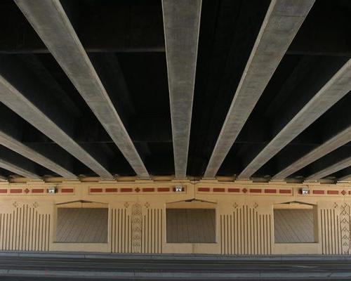 View of 桥 piers and decking from beneath highway overpass